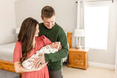parents holding their newborn baby