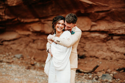 bride and groom standing on dune buggy