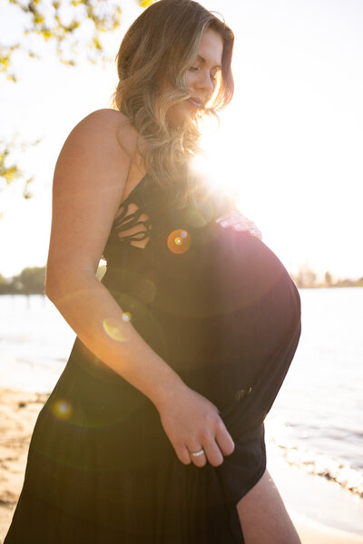 Black and white image of pregnant couple by family portrait photographer vancouver
