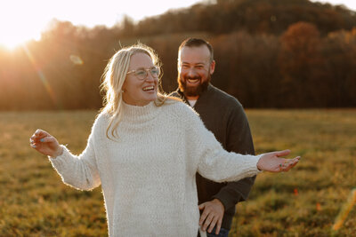 couple laughing during golden hour engagement