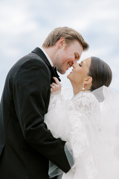 bride hugging groom from behind