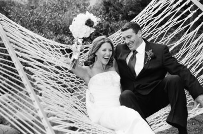 Palisades Tahoe wedding of bride waiting in helicopter to fly over and land on KT at Palisades. The couple's first date was skiing. Black and white film image