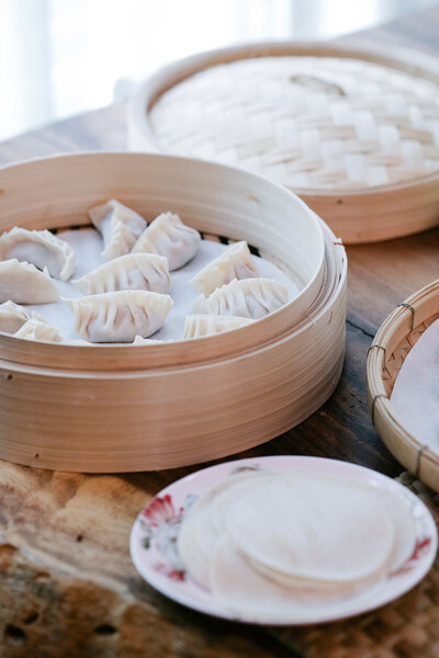 Dim sum plated on natural wood and ceramic plates.