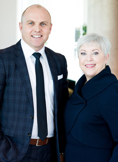 corporate headshots of a distinguished male and female in blue business  suits taken by Ottawa Headshot Photographer JEMMAN Photography Commercial