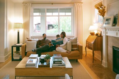 family of three reading to son at home