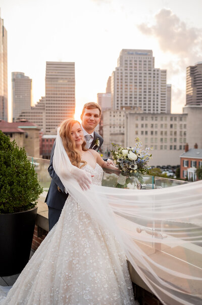 Dive into the romance of Ken and Lindsey's wedding portrait, captured in a breathtaking dip in front of Cincinnati's iconic Music Hall. This striking image epitomizes elegance and drama, with Music Hall's grand architecture providing a stunning backdrop. Lindsey's flowing gown and the couple's joyful expressions bring to life the love and excitement of their special day. Perfect for couples looking for inspirational and iconic wedding photography, this photo highlights how a historic venue and a classic pose can create a timeless and memorable wedding moment.