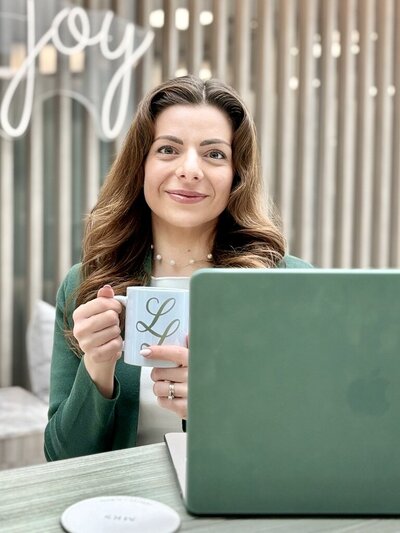 Luisa sits in her office space.