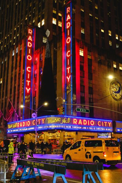 A vibrant and bustling Times Square in New York City, filled with illuminated billboards, towering skyscrapers, and crowds of people soaking in the electric atmosphere. This iconic destination reflects the excitement and opportunities supported by vacation fundraising for charities.