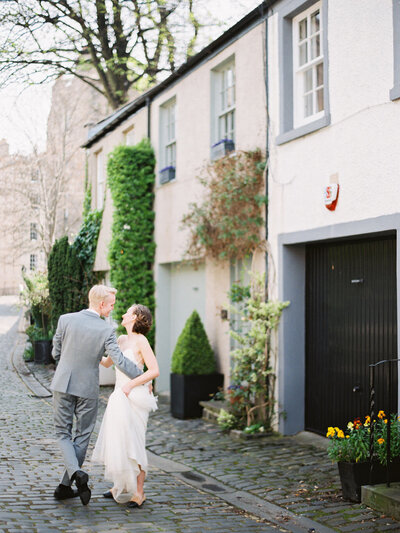 Honeymoon session in Edinburgh Scotland at Circus Lane Bride and groom are dancing in the street