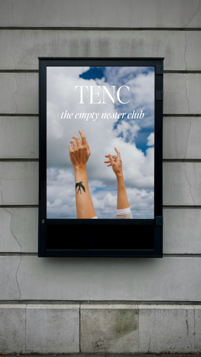A poster on a wall shows two raised arms against a cloudy sky with the text "TENC the empty nester club. Mockup by Sweet Pea Ink Creative.
