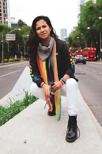 latina lesbian crouching in the middle of a street