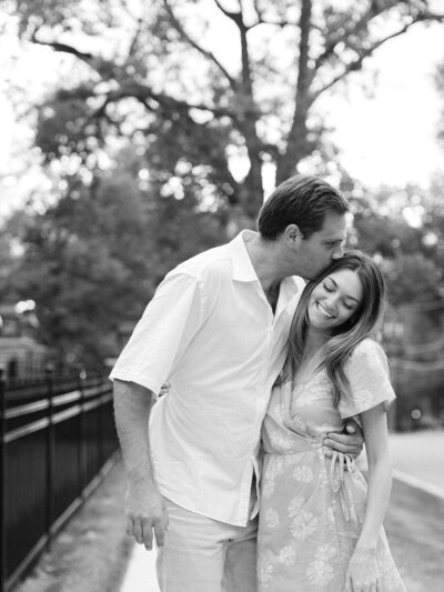 engaged couple kissing 