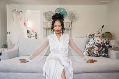 Bride getting ready in a luxurious silk robe, preparing for her special day in Raleigh, NC.