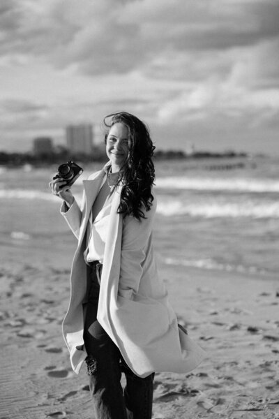 Brooke Pitchford holding her camera at the beach in Chicago