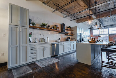 Kitchen with open concept layout, open beam ceilings, and modern feel in this vacation rental condo in downtown Waco, TX