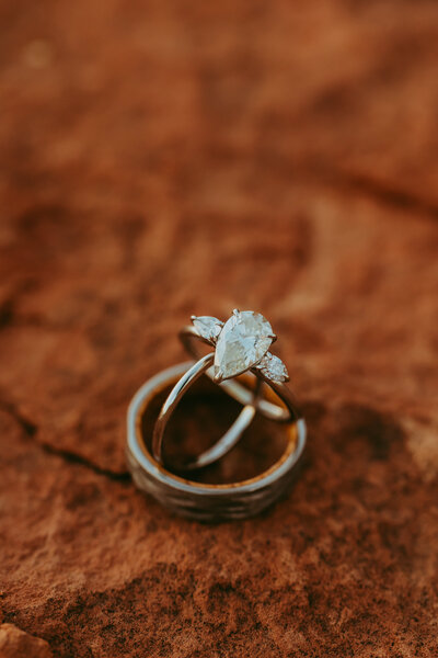 wedding rings stand up with red rock sand stone surrounding them