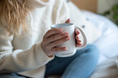 Person sitting with a cup