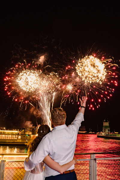 Bride and groom watch fireworks off on Chicago's First Lady Cruise.