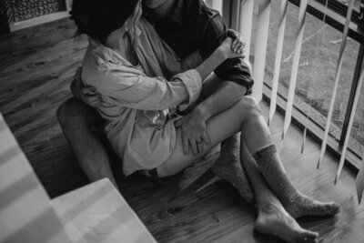 Close up of couple almost kissing, him laughing and her holdin g his face with both hands