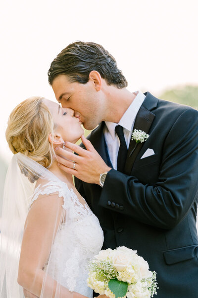 photo of bride and groom kissing