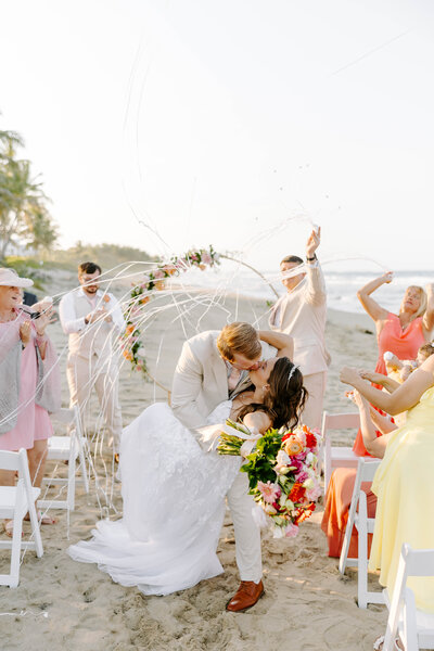 groom dipping bride post-ceremony on the beach in the Dominican Republic