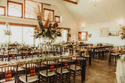 The ballroom at Hidden Hill Events Venue with tables and chairs set up and decorated.