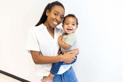 Mother holding her baby on her hip, smiling