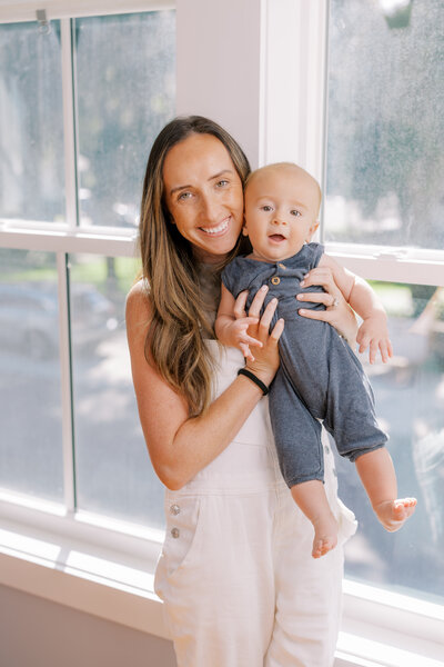 Warm light woman holding beautiful baby photoshoot