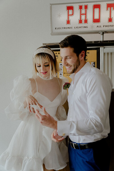Las Vegas elopement couple smiling outside photo booth