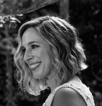 Meghan Matthies smiling in black and white portrait — founder of Leaving Main Street travel blog about expat life abroad