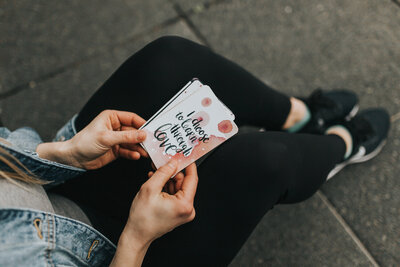 woman holding cards