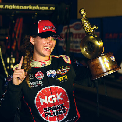 megan meyer smiling while holding a trophy