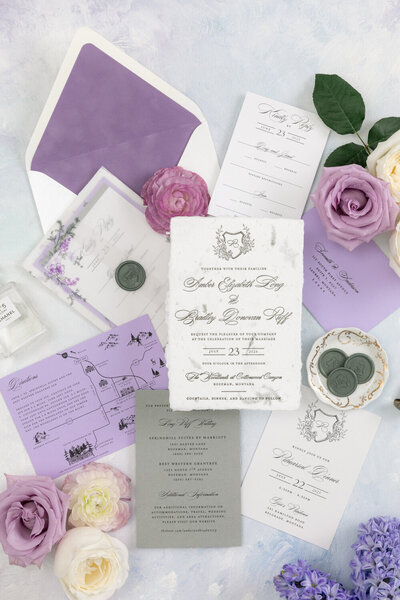 Purple and green summer Montana letterpress wedding invitations featuring handmade paper, custom map, and wax seals.