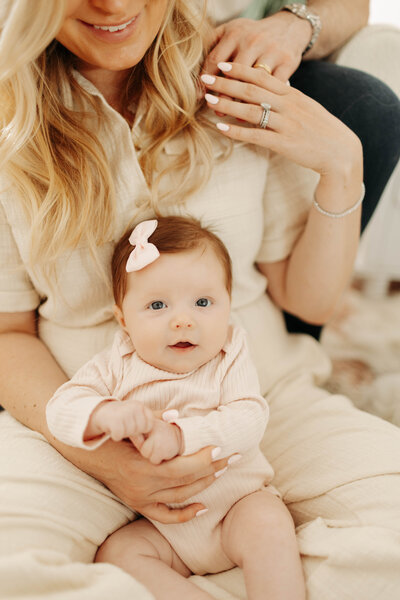close-up of newborns hands in a chunky sweater, with blurred view of baby's lips during relaxed lifestyle newborn session in California 