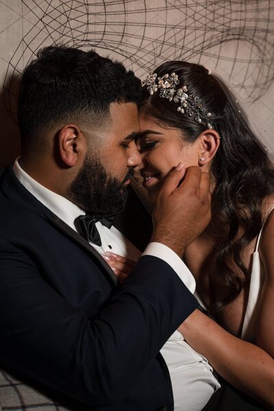 Bride and groom sharing an intimate moment after their wedding ceremony at The Union Club Hotel at Purdue University.