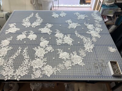 process of placing lace appliques onto a custom lace bridal veil with vintage heirloom lace