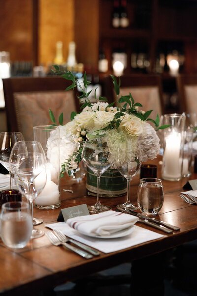 An outdoor wedding reception table with white linens and mid-century chairs. The wedding was held at the Royal Palms in Phoenix, Arizona.