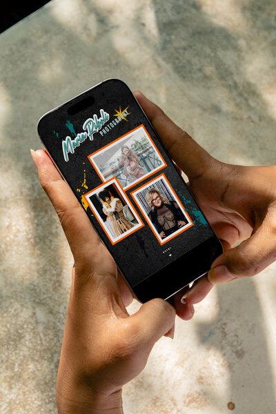 Girl holding her phone looking at photography website