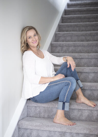 Woman posing while sitting on the stairs
