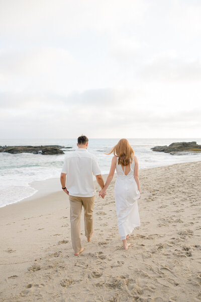 couple walking away on the beach