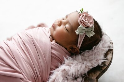 newborn girl sleeping on side on peach fur | Pittsburgh Newborn and Family Photography
