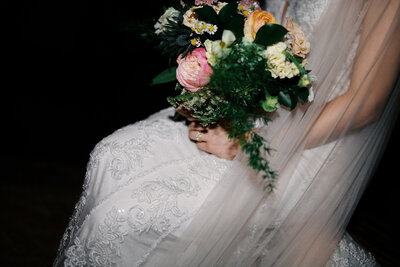 Romantic close-up of newlyweds embracing in soft backlight, styled and shot by a luxury Florida wedding photographer with a documentary approach