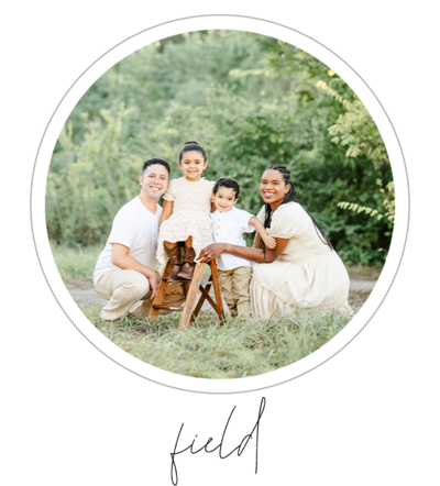 The photo captures an outdoor family session in a field with lush green foliage and a forest backdrop. The photographer, Bri Sullivan, captures the mom, dad, daughter, and son as they pose for their photo. The scene showcases the beauty of nature and the joy of family moments together.