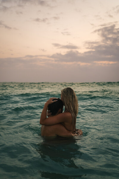 Couple hugging in the ocean