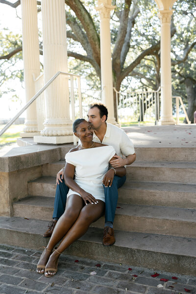 bride and groom walking down estate path twirling the bride