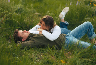 couple laying the grass 