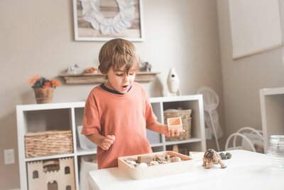 child plays with wooden toys