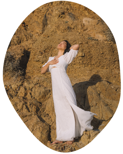 Joanne Lai, the somatic therapist, standing in sunshine on cliffside.