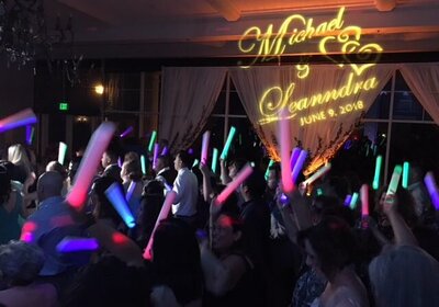 Dream about a packed dance floor with guests dancing and waving neon glow sticks of vibrant reds, greens, blues to the solid beat of a  top notch DJ duo with a beautiful gobo in amber of the wedding couple's name.