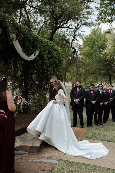 photo of bride and groom during wedding ceremony at Cross Creek Ranch, a Dallas Wedding Venue